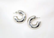 Pair of silver hoop earrings on a white background